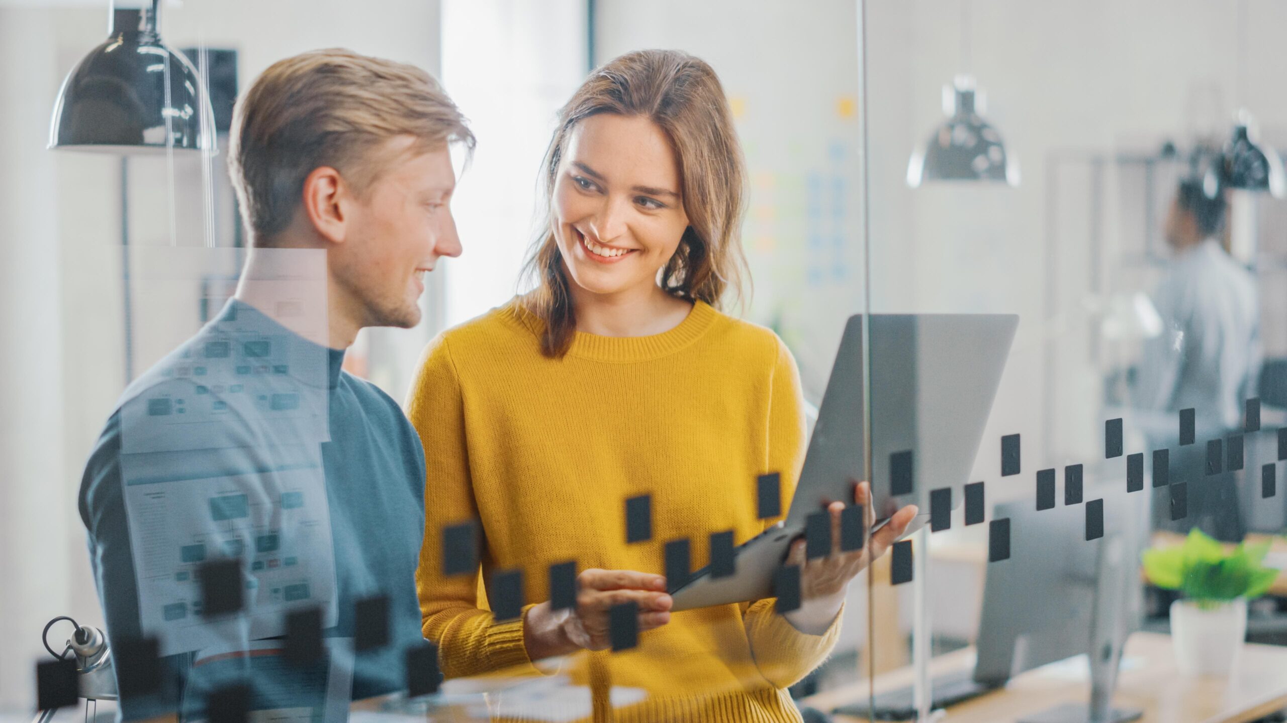 man-woman-are-looking-tablet-glass-wall
